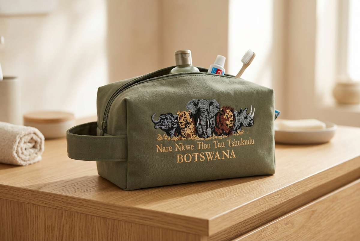 Olive green Big Five toiletry bag on a table with travel essentials inside