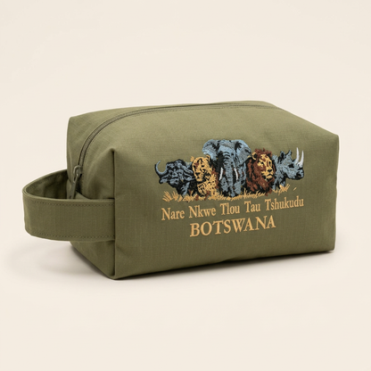 Olive green canvas toiletry bag with Botswana wildlife embroidery and side carry handle on a clean studio background.